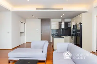 Spacious and modern open-plan living area seamlessly connecting to a fully equipped kitchen with high-end appliances, perfect for entertaining and comfortable living.