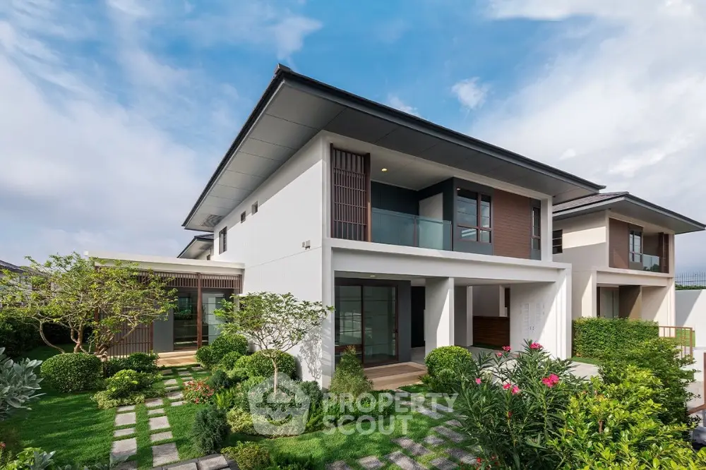 Modern two-story house with lush garden and contemporary design