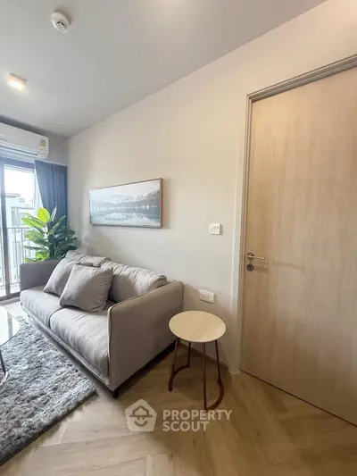 Modern living room with cozy sofa and stylish decor in a bright apartment.