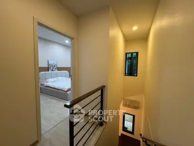 Modern hallway leading to a cozy bedroom with stylish decor