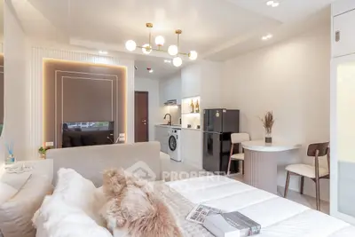 Modern studio apartment with open layout, featuring cozy living area, compact kitchen, and stylish decor.