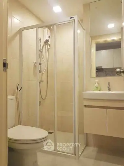 Modern bathroom with glass shower enclosure and sleek fixtures