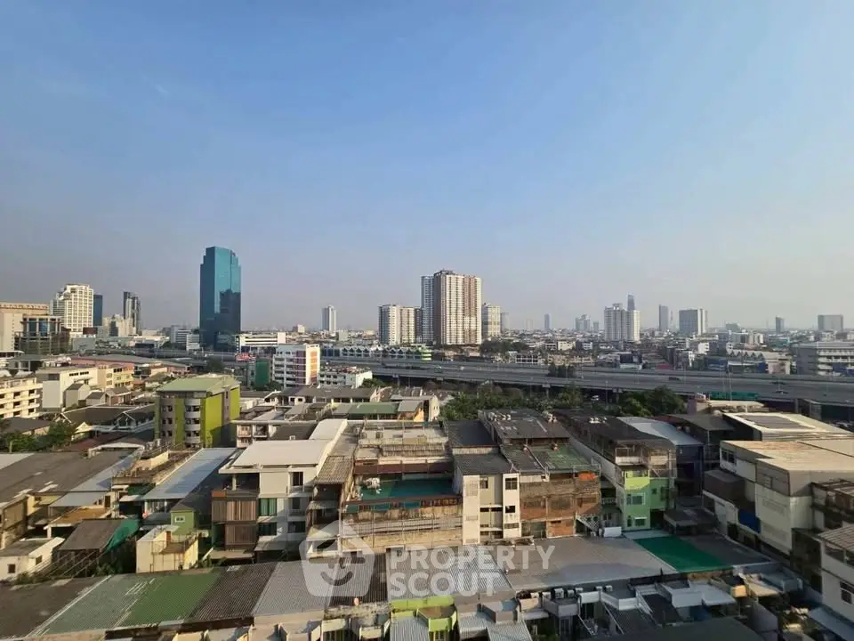 Stunning cityscape view showcasing urban skyline and residential buildings under a clear blue sky.
