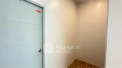 Minimalist interior with wooden flooring and modern door design