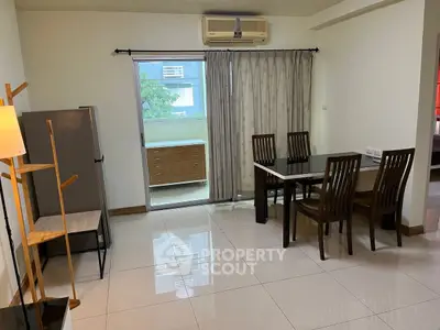 Spacious dining area with modern furniture and natural light in a stylish apartment.