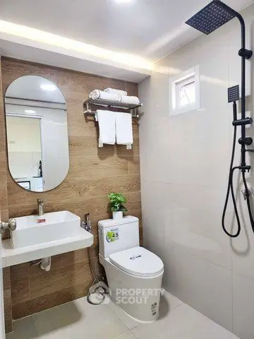 Modern bathroom with sleek fixtures and wooden accent wall