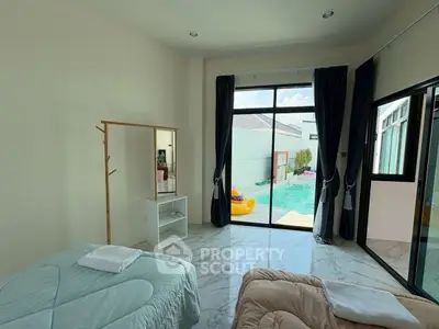 Spacious bedroom with pool view and modern decor