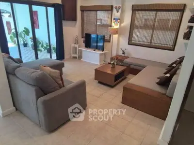 Spacious living room with modern furniture and large windows for natural light.