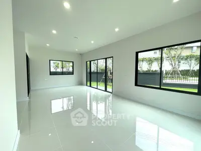 Spacious modern living room with large windows and garden view