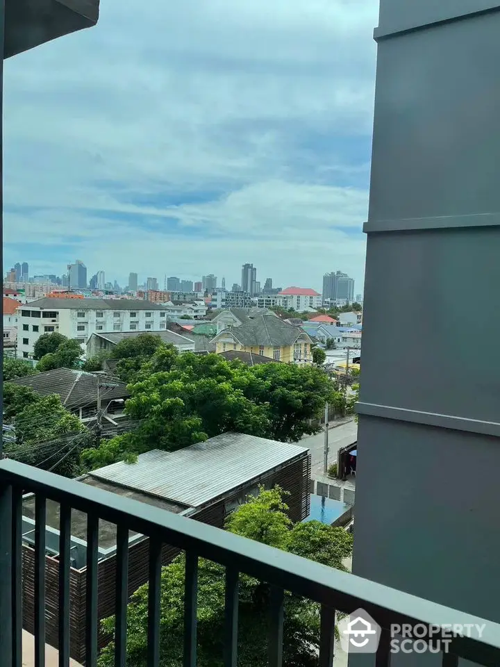 Stunning cityscape view from a modern balcony in a high-rise apartment.