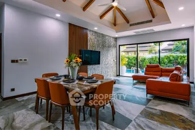 Luxurious living room with modern decor, spacious seating, and pool view, perfect for relaxation and entertainment.