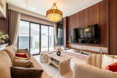 Luxurious living room with elegant chandelier and pool view