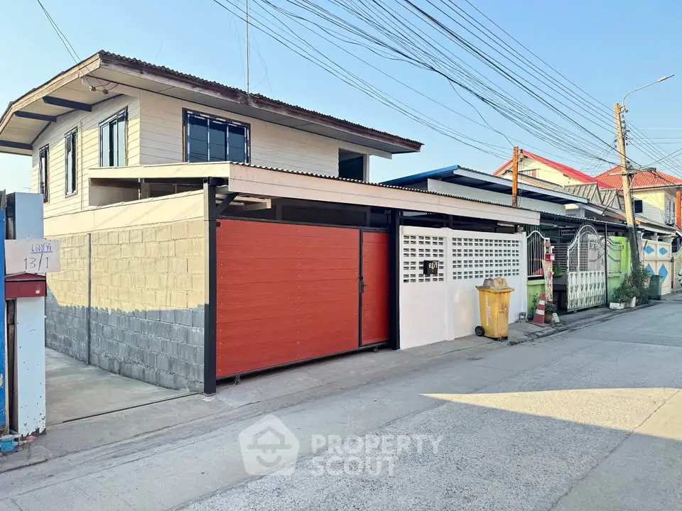 Charming two-story house with modern facade and spacious driveway in a quiet neighborhood.