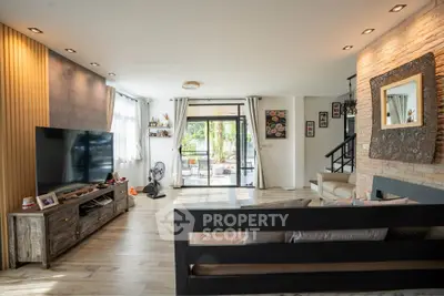 Spacious living room with modern decor and large windows for natural light.
