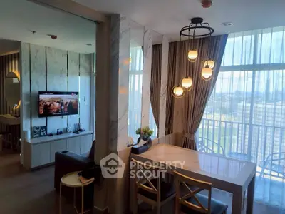 Modern living and dining area with stylish lighting and large windows.