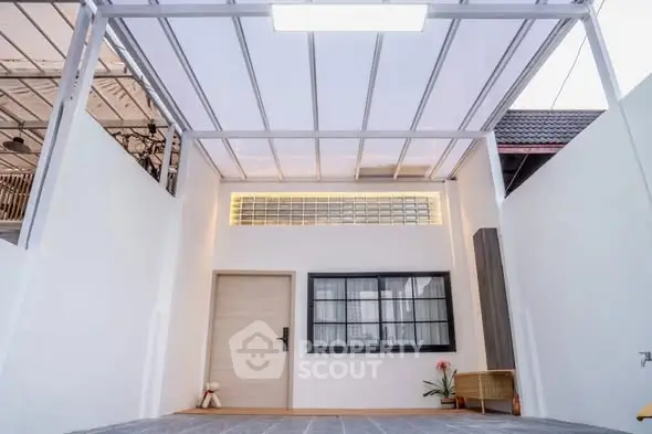 Modern minimalist home entrance with sleek design and ample natural light