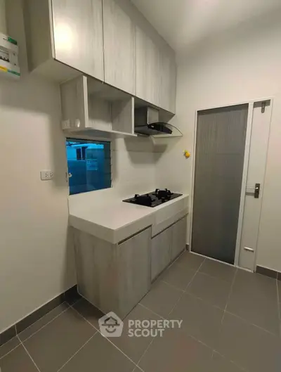 Modern kitchen with sleek cabinets and gas stove in minimalist design