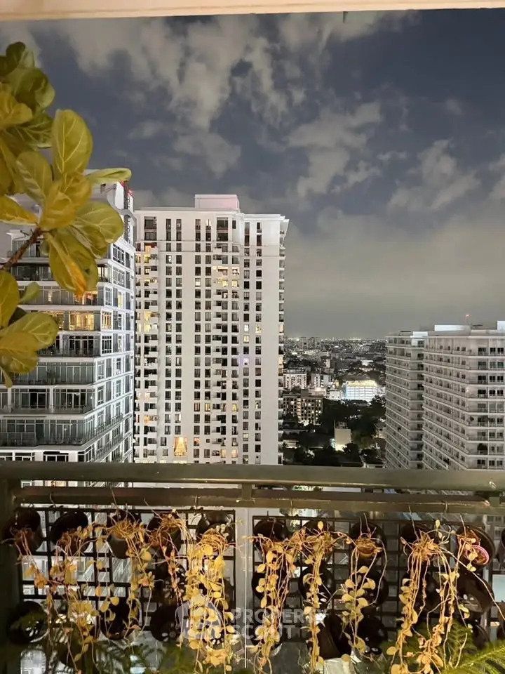 Stunning cityscape view from a high-rise balcony with lush greenery and skyline backdrop.