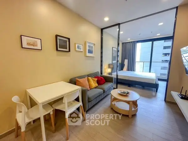 Modern studio apartment with cozy living area and spacious bedroom, featuring stylish decor and natural light.