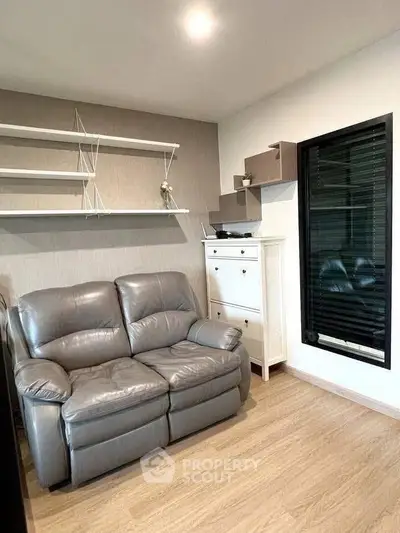 Cozy living room with modern gray sofa and stylish shelving