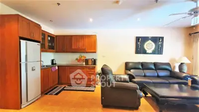 Spacious living room with modern kitchen and cozy seating area