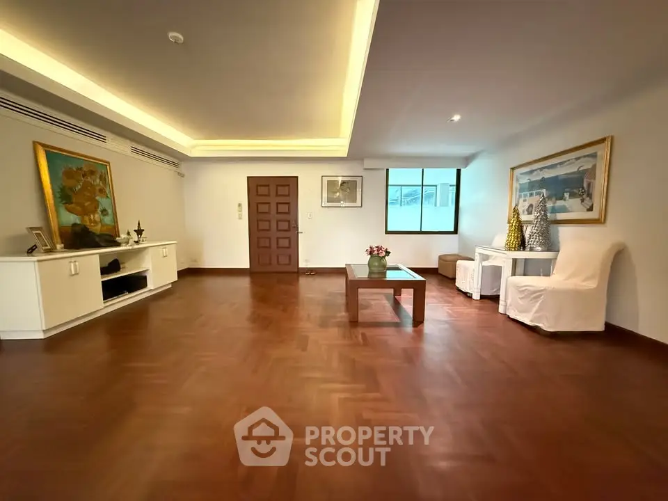Spacious living room with elegant wooden flooring and stylish decor