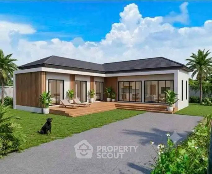 Modern single-story home with large windows, wooden deck, and lush garden under a clear blue sky.