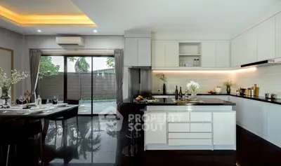 Luxurious modern kitchen with sleek black countertops and open layout, perfect for entertaining.