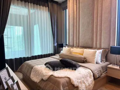 Luxurious bedroom with elegant decor and large windows for natural light