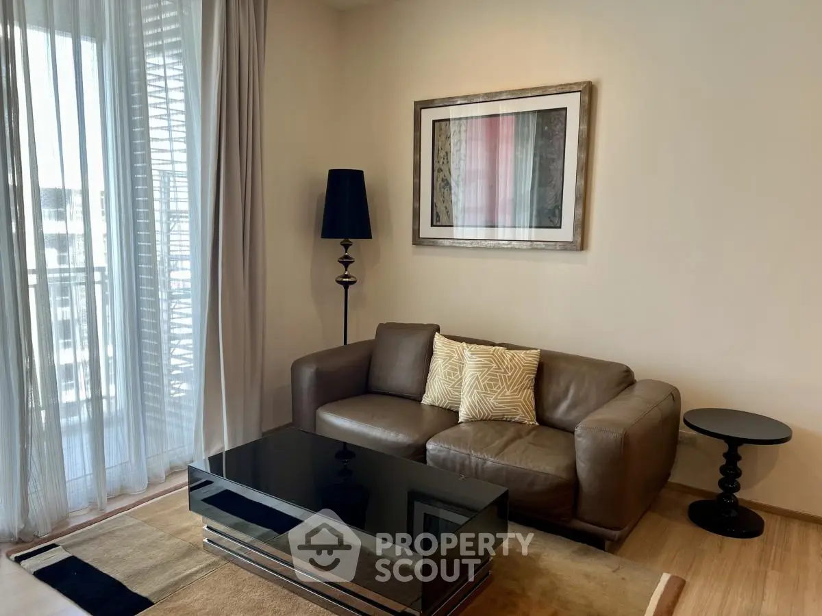 Stylish living room with modern decor and natural light, featuring a cozy sofa and elegant coffee table.