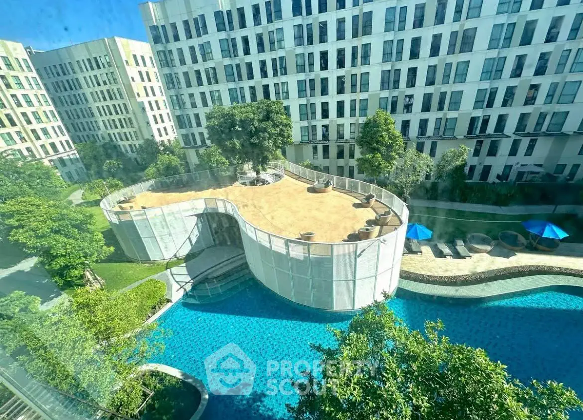 Luxurious apartment complex with stunning pool and lush garden views