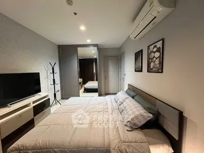 Modern bedroom with stylish decor and air conditioning in a cozy apartment.