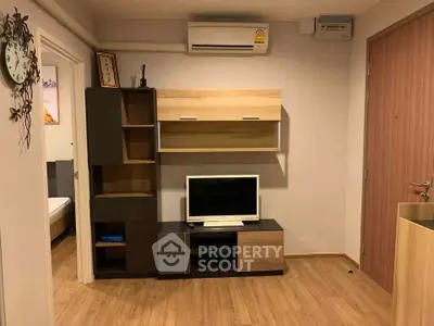 Modern living room with stylish wooden furniture and wall-mounted air conditioner.