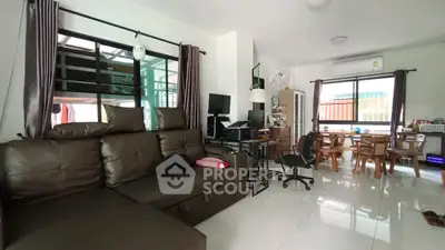 Spacious living room with modern furniture and dining area, perfect for family gatherings.