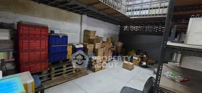 Spacious storage area with organized shelves and boxes, ideal for warehouse or commercial use.