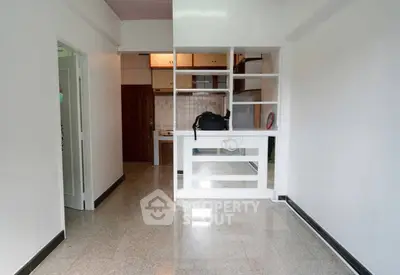 Spacious open-plan living area with modern shelving and glossy floors