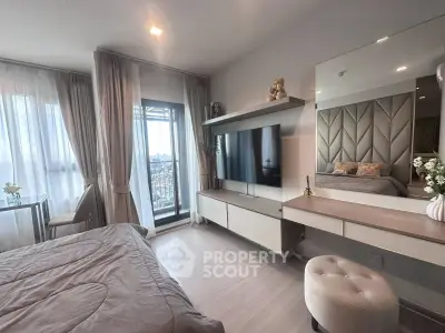 Luxurious bedroom with modern decor and balcony view in high-rise apartment.