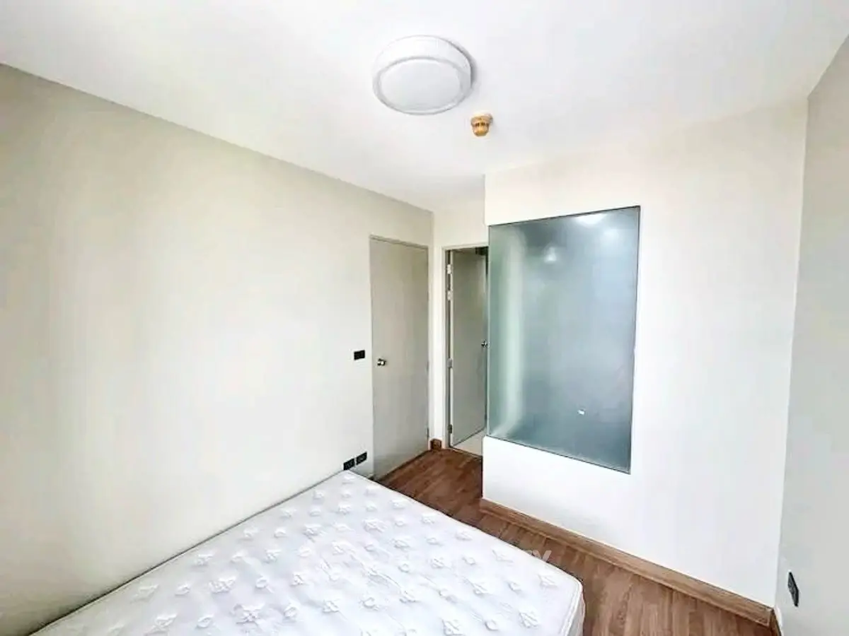 Bright minimalist bedroom with modern design and wooden flooring