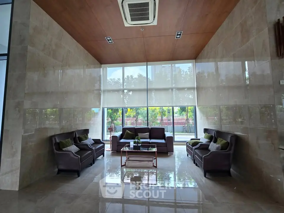 Luxurious lobby with elegant seating and large windows offering garden views.