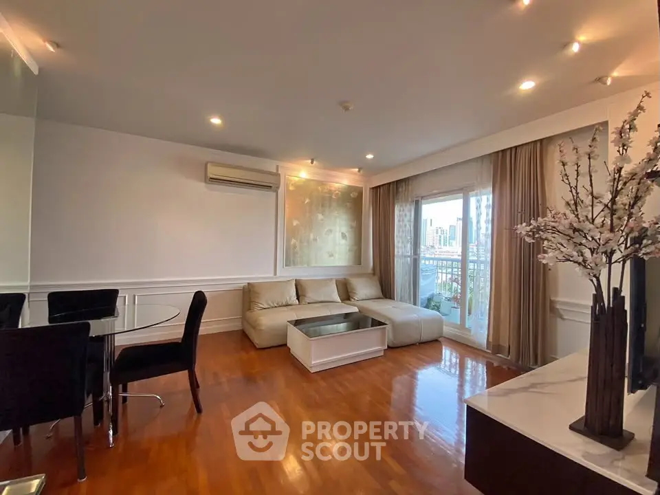 Spacious living room with elegant decor and city view balcony