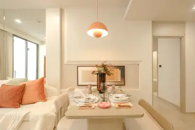 Modern dining area with elegant decor and soft lighting in a stylish apartment interior.