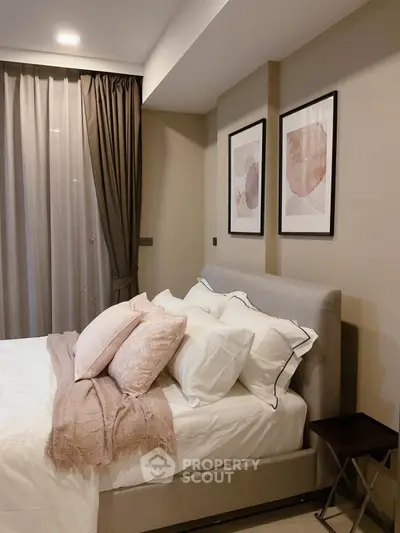 Elegant bedroom with modern decor and cozy bedding in a stylish apartment.