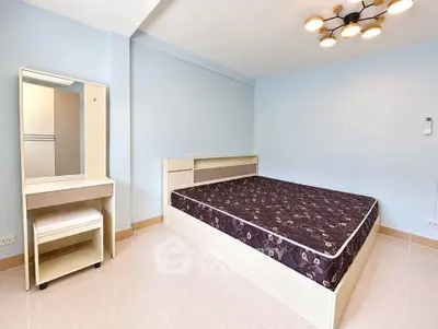 Spacious bedroom with modern lighting and minimalist furniture in a serene setting.
