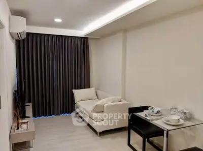 Modern living room with cozy sofa and dining area in a stylish apartment.