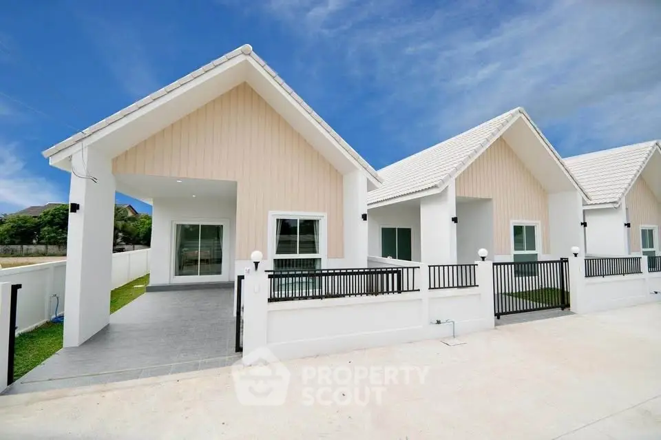 Charming modern single-story homes with white facades and gabled roofs, perfect for family living.