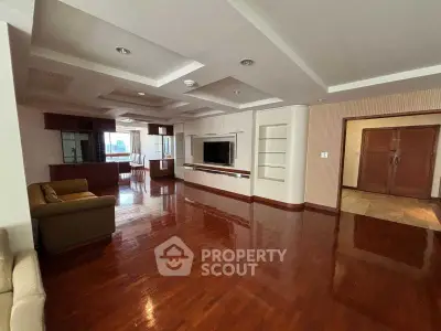 Spacious living room with wooden flooring and built-in entertainment center