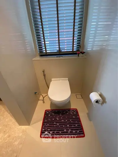 Modern bathroom with sleek toilet and stylish blinds