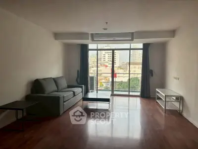 Spacious living room with city view and modern furnishings