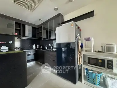 Modern kitchen with sleek black cabinetry and stainless steel appliances