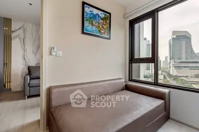 Modern apartment with city view and stylish decor, featuring a cozy seating area.